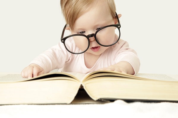 Baby exploring a thick book