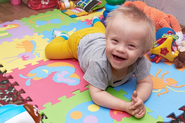 Baby boy smiling on playmat